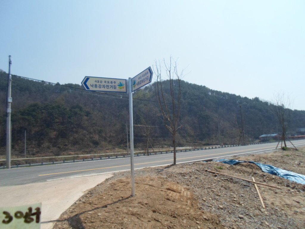 신설 자전거 도로 비탈면에 수평을 맞춰 정밀 시공된 방향 표지판